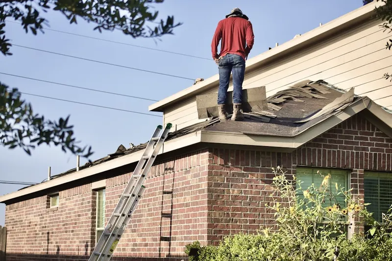 Professional roofer working on a residential roof in Butner